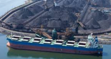 Aerial view of a bulk carrier loading coal at an export terminal