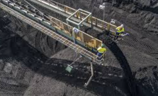 Coal mining operations with conveyor and workers